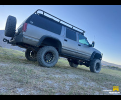 1999 purpose built GMC suburban with M105 custom camp trailer and roof top tent